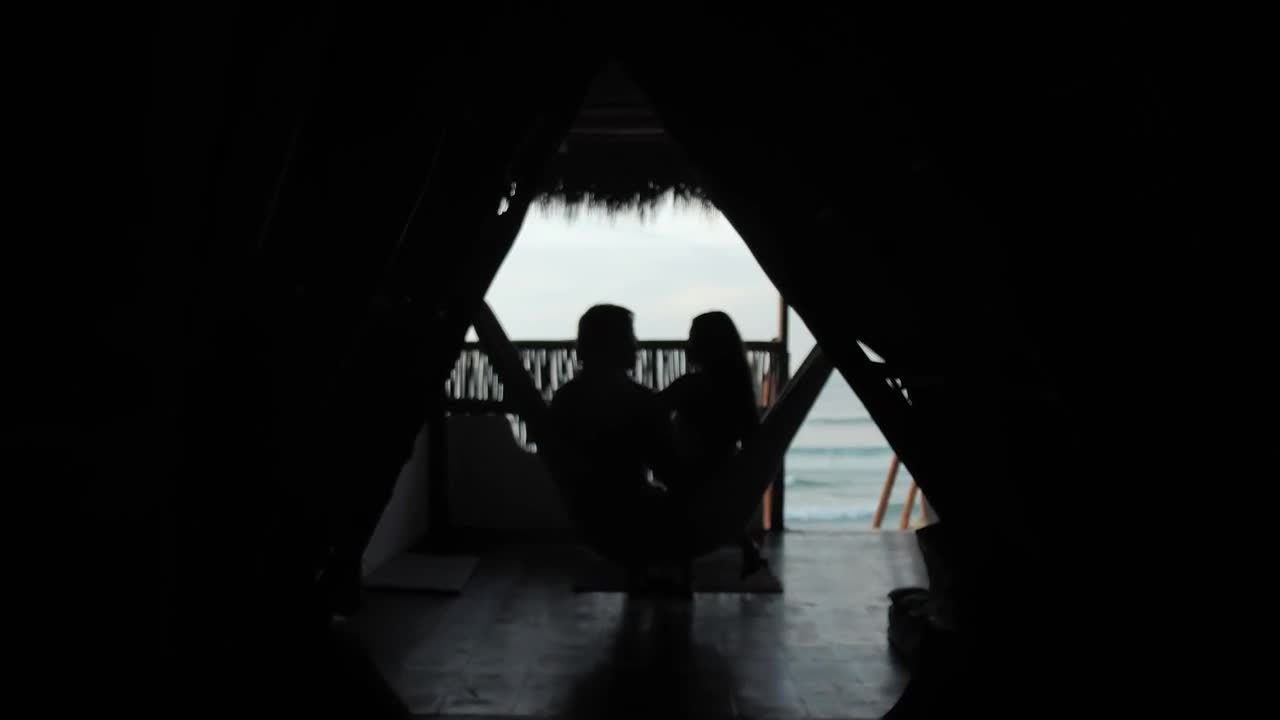 Download Stock Video A Couple In A Hammock At A Beach Hut Live Wallpaper for PC