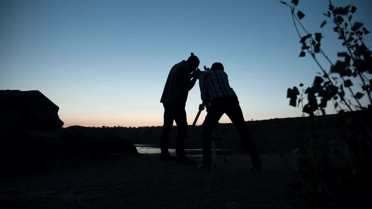 Download Stock Video A Couple Of Friends Stargazing Using The Telescope Live Wallpaper for PC