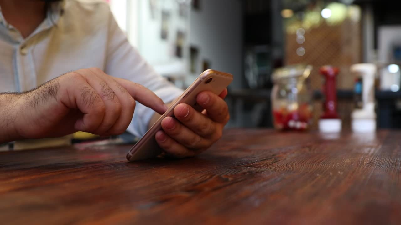 Download Stock Video Adult Man In A Restaurant Viewing His Cell Live Wallpaper for PC