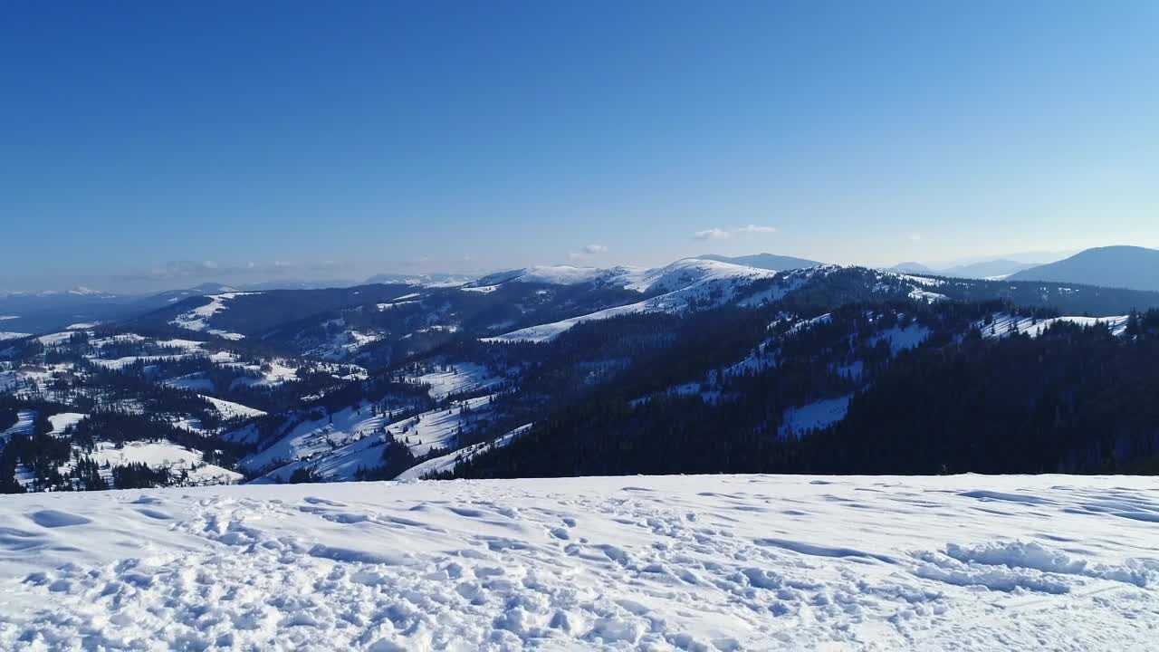 Download Stock Video Aerial Shot From The Top Of A Snowy Mountain Live Wallpaper for PC