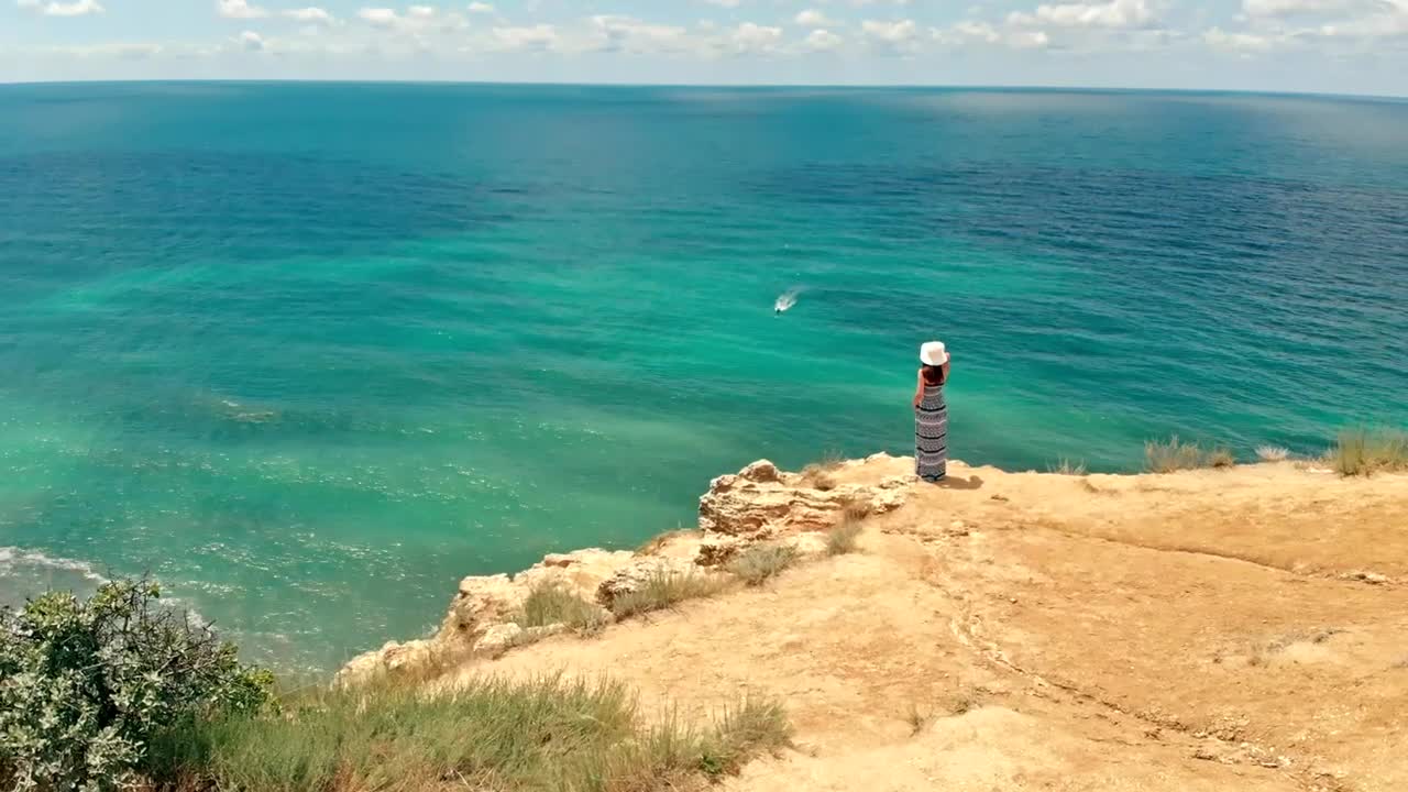 Download Stock Video Aerial View Of A Woman Looking Out To Sea From Live Wallpaper for PC