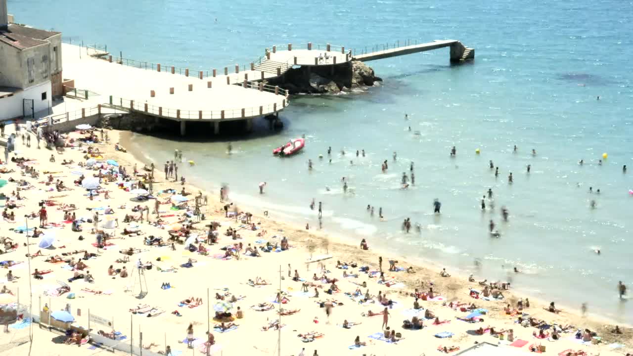 Download Stock Video Beach Full Of Tourists Next To The Pier Live Wallpaper For PC