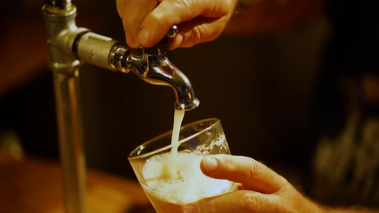 Download Stock Video Bartender Serving Beer From A Tap In A Glass In Live Wallpaper For PC