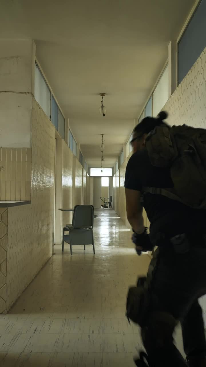 Download Stock Video Armed Man Securing An Area In An Empty Building Live Wallpaper For PC