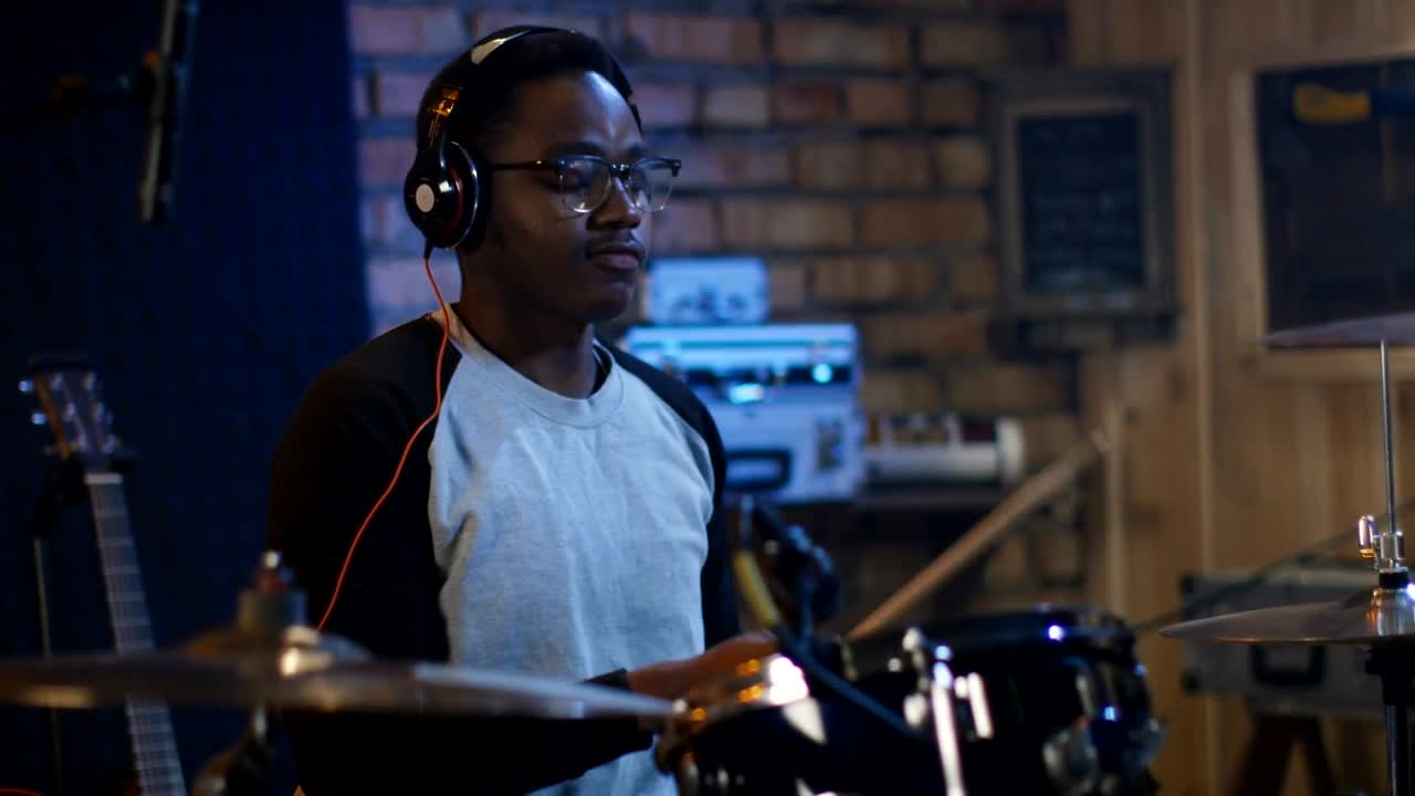 Download Stock Video A Young Man With Headphones Playing The Drums Live Wallpaper For PC