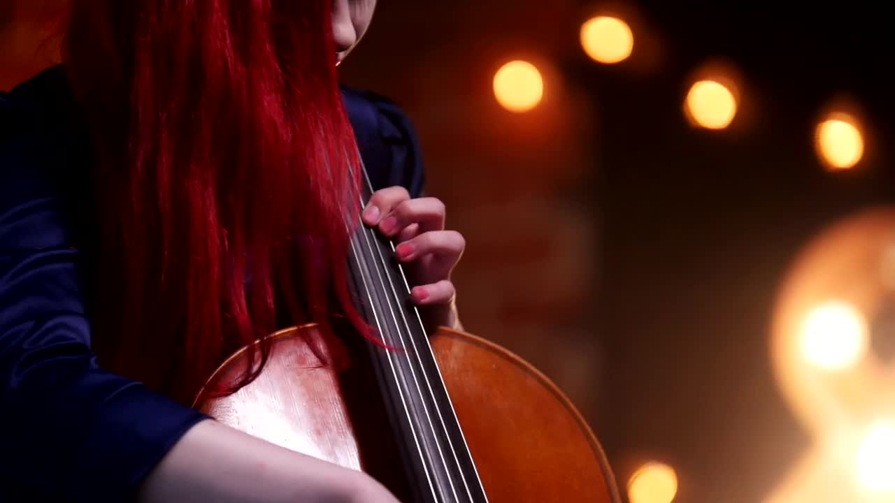 Download Stock Video A Woman With Red Hair Plays The Cello Live Wallpaper For PC