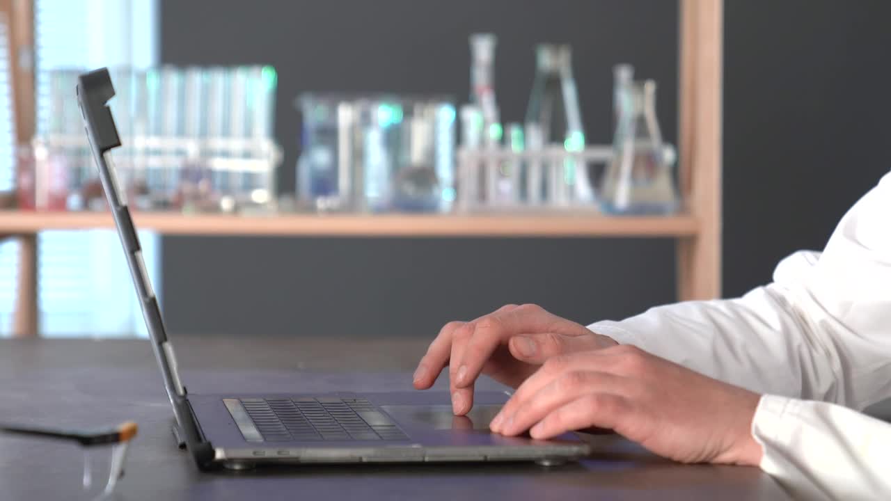 Download Stock Video A Scientist Typing On A Laptop In The Lab Live Wallpaper For PC