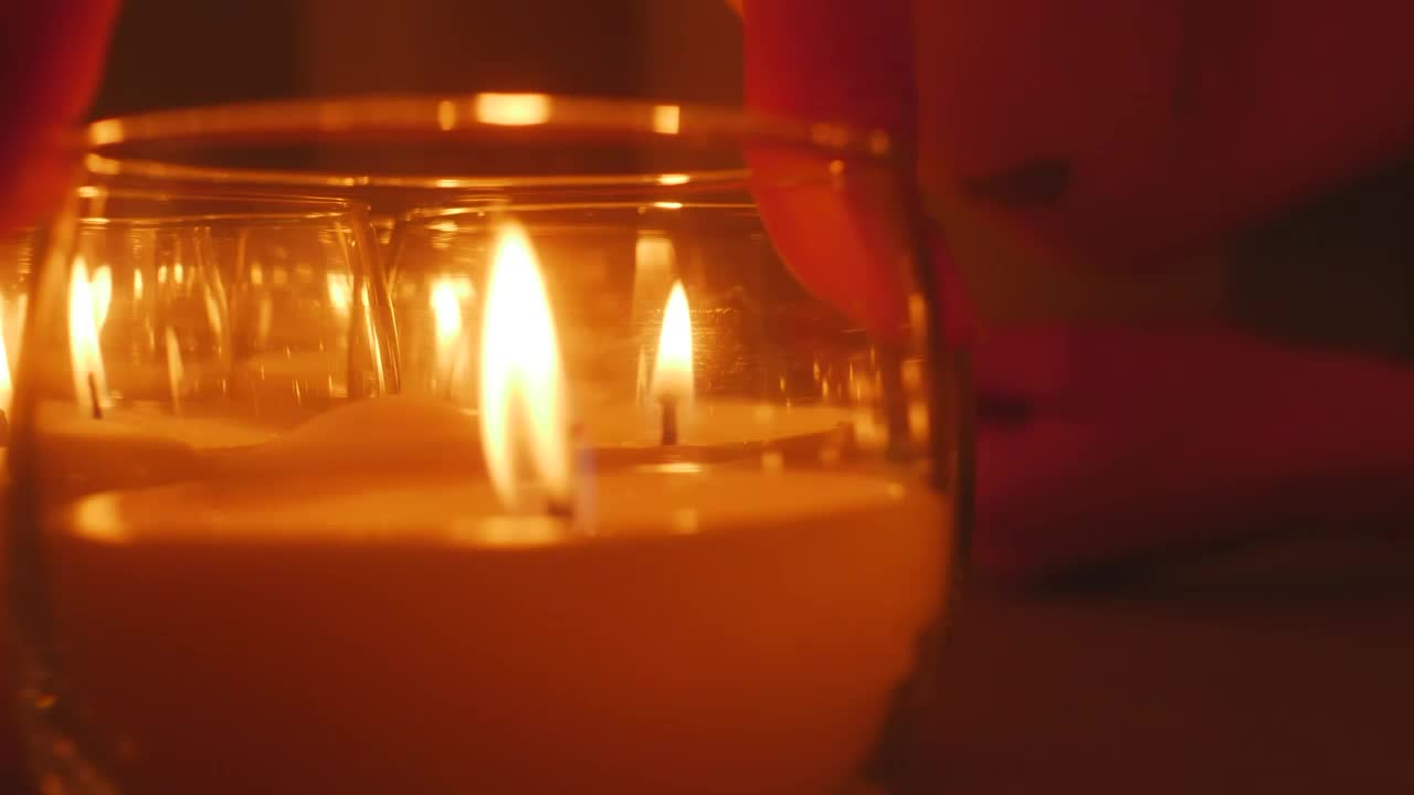 Download Stock Video A Persons Hand Accommodating Small Candles Live Wallpaper For PC