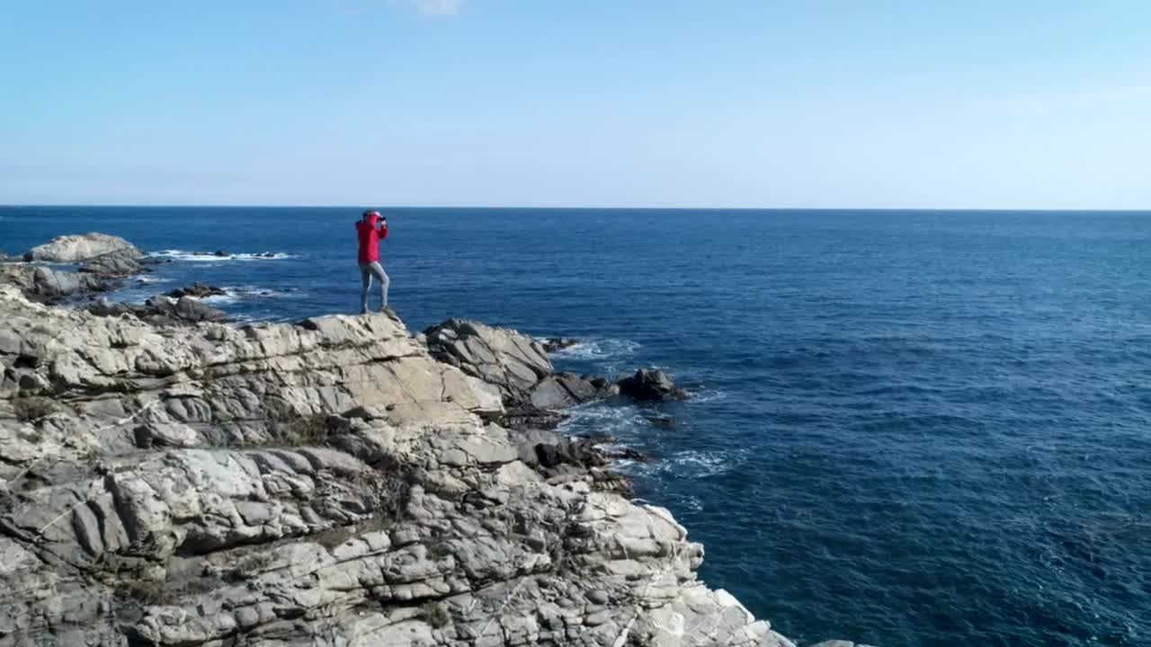 Download Stock Video A Person Taking Pictures Standing On A Cliff Live Wallpaper For PC