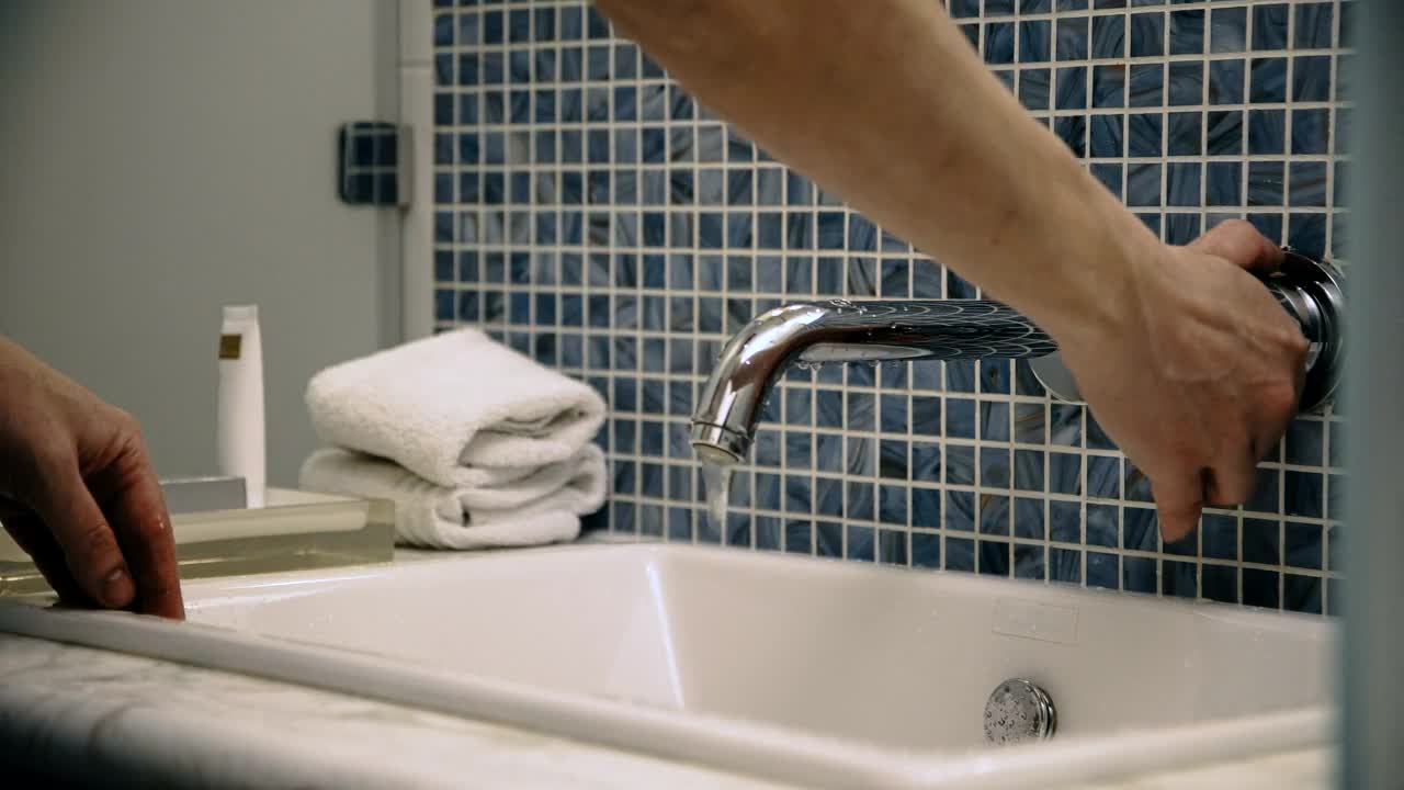 Download Stock Video A Man Washes His Face In The Bathroom Sink Live Wallpaper For PC