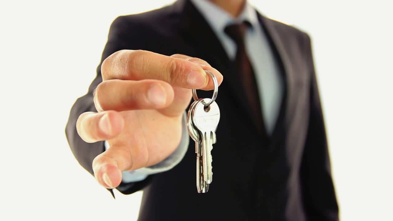 Download Stock Video A Man In Suit Handing Keys To The Lens Live Wallpaper For PC