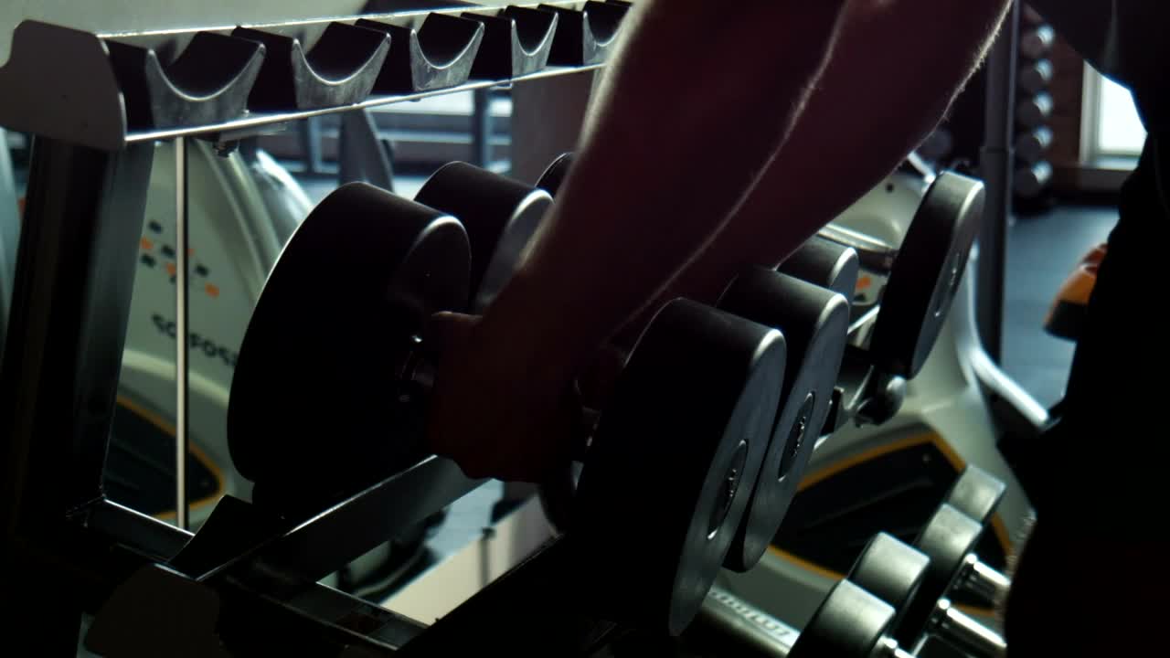 Download Stock Video A Guy Taking The Dumbbells In The Gym Live Wallpaper For PC