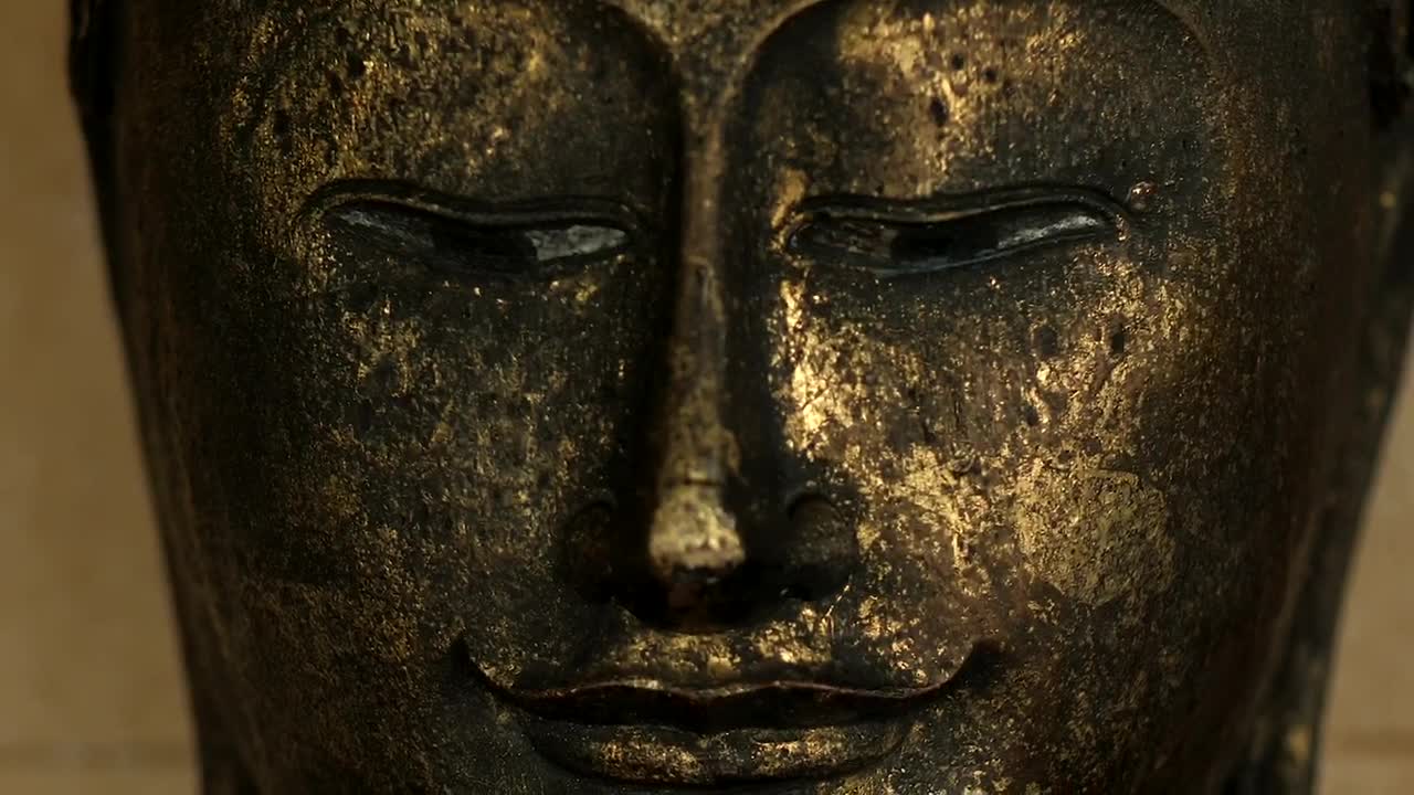 Download Stock Video Buddha Face From A Metal Statue Live Wallpaper For PC