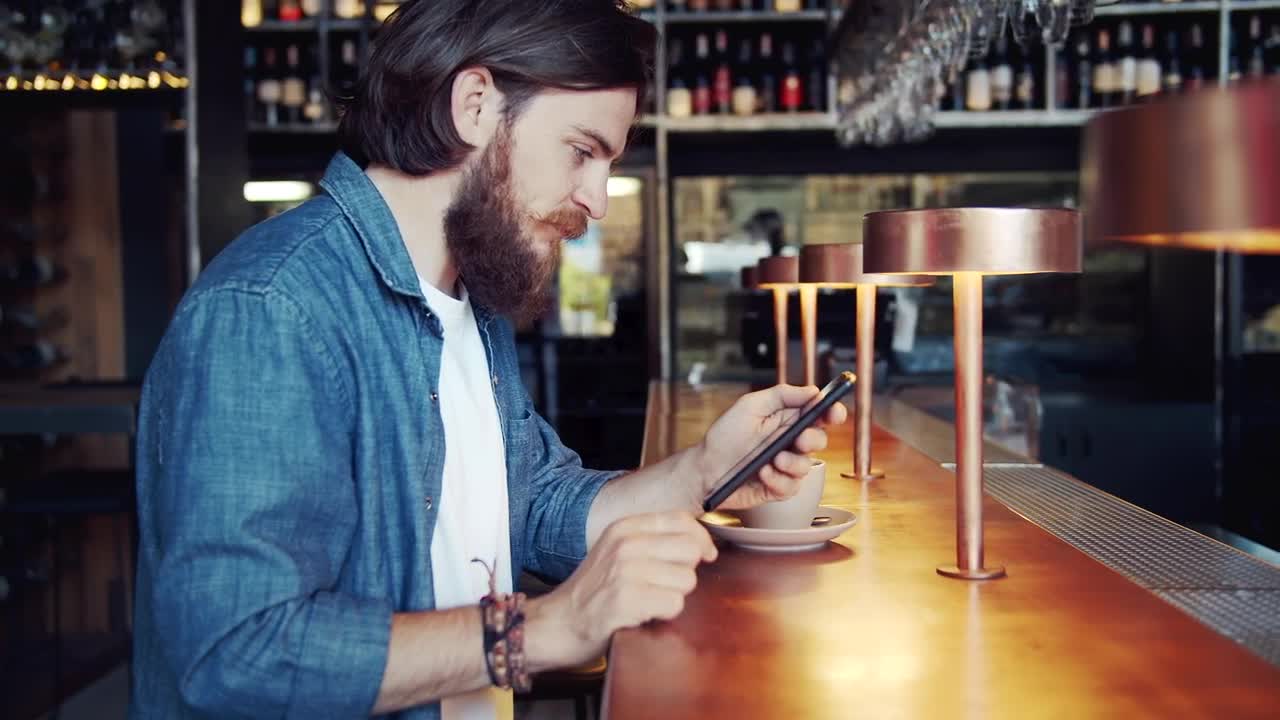 Download Stock Video Bearded Man Uses Mobile App In Urban Bar Live Wallpaper For PC