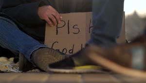 Download Video Stock Cardboard Sign Of A Homeless Man On The Street Live Wallpaper For PC