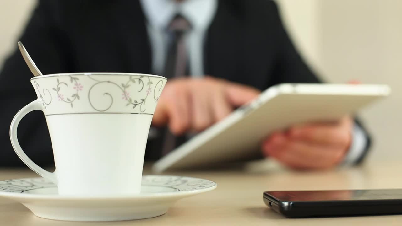 Download Video Stock Businessman With A Tablet Drinking Coffee Live Wallpaper For PC