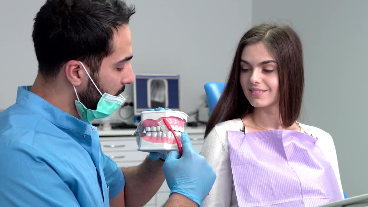 Download Stock Video Dentist Shows Woman Proper Teeth Brushing Live Wallpaper For PC