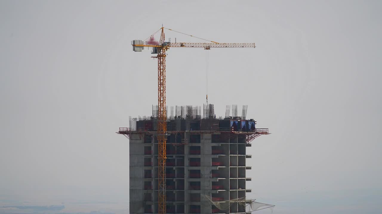 Download Stock Video Crane And Construction Workers At The Top Of A Building Live Wallpaper For PC