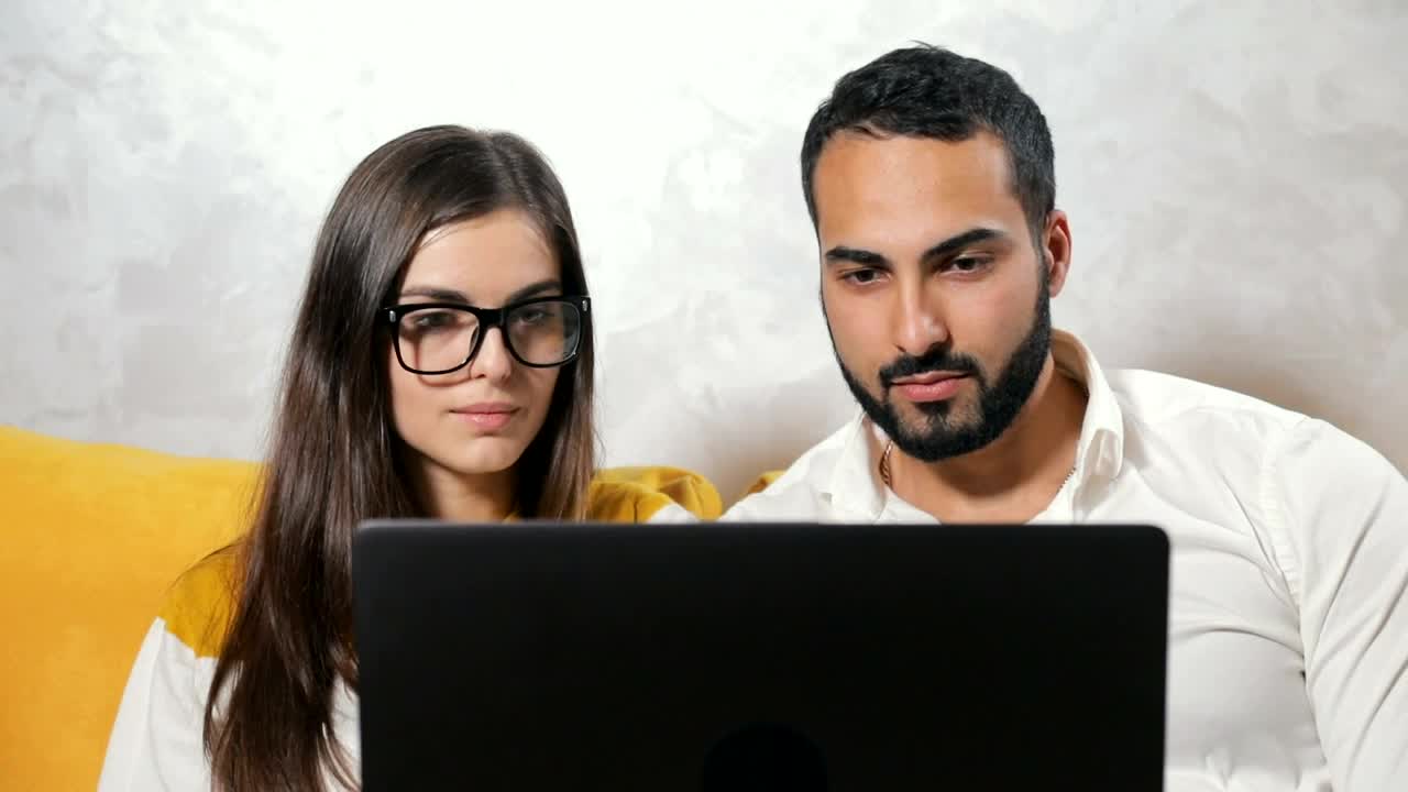 Download Stock Video Couple Surprised By What They See On Their Laptop Live Wallpaper For PC