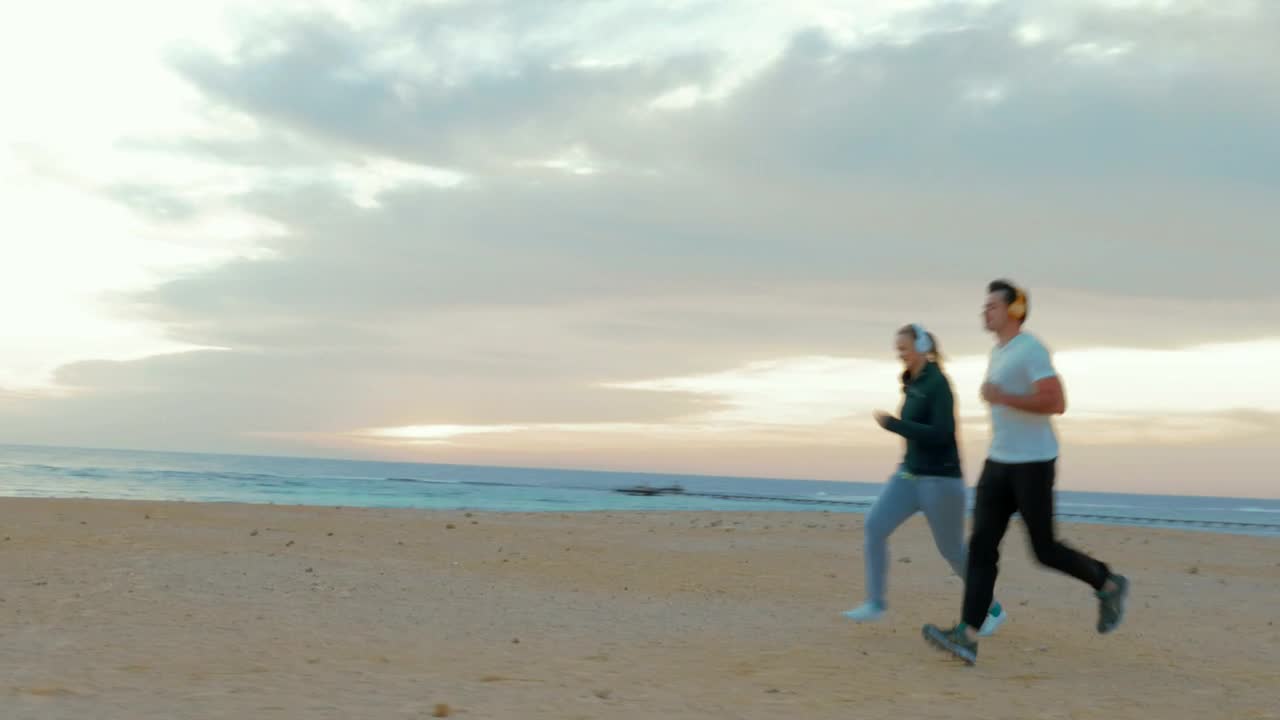 Download Stock Video Couple Out For A Run On The Beach Live Wallpaper For PC