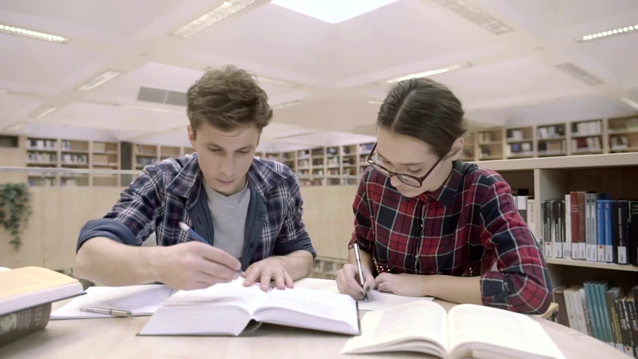 Download Stock Video Couple Of Students At The Library Live Wallpaper For PC