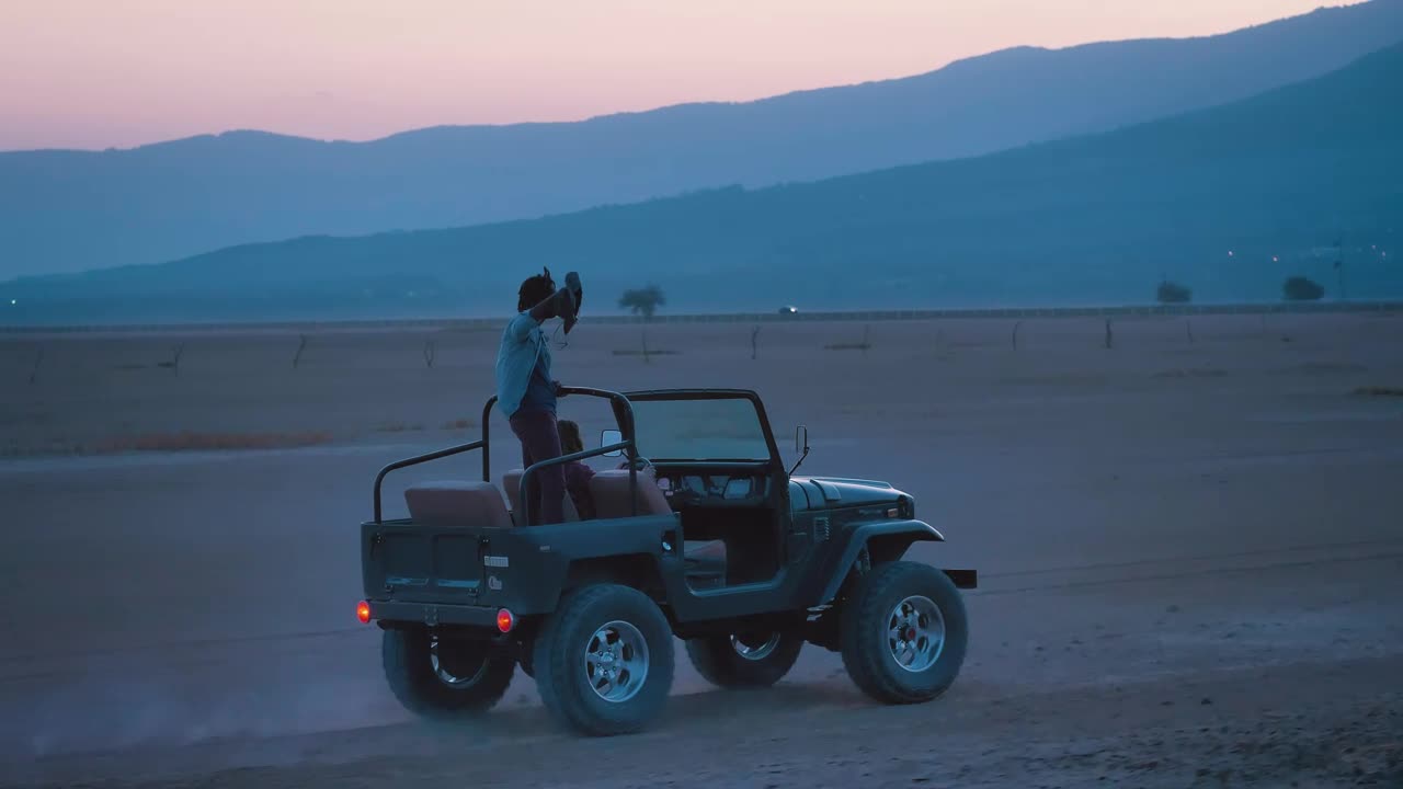 Download Stock Video Couple Of Friends Traveling Through A Desert On A Road Live Wallpaper For PC