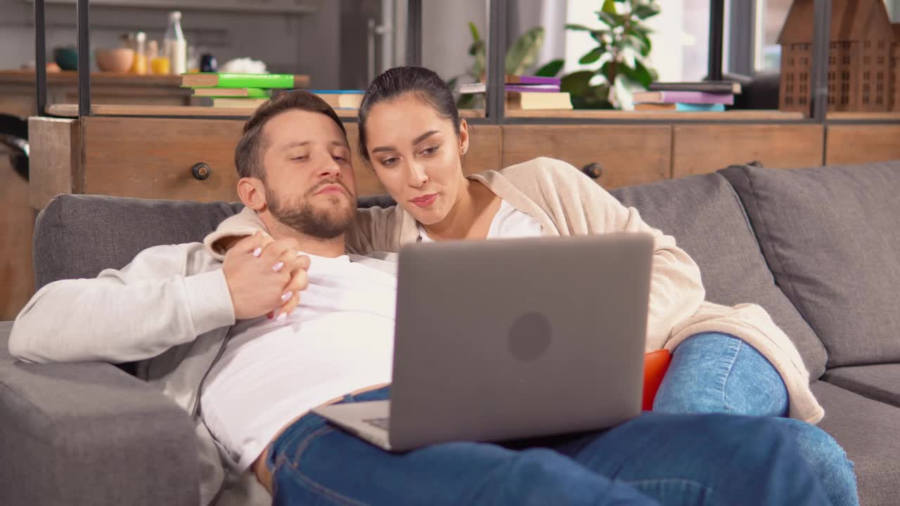 Download Stock Video Couple Holding Each Other In An Armchair Watching A Movie Live Wallpaper For PC