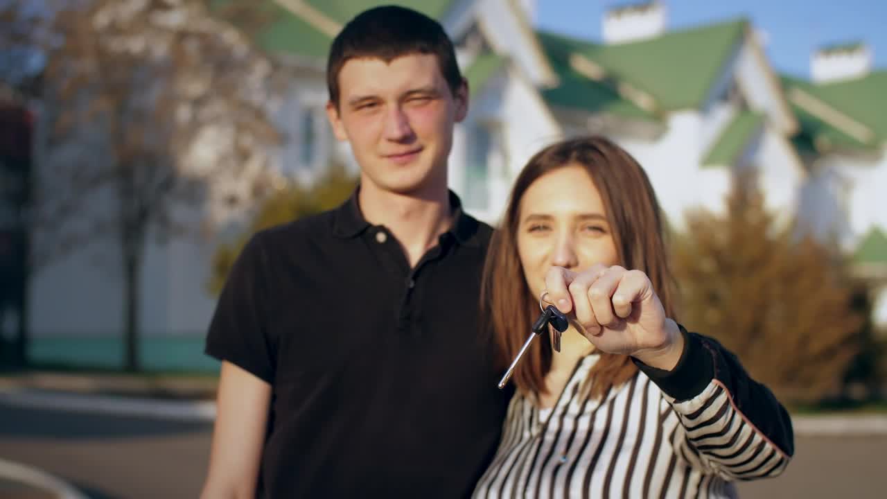 Download Stock Video Couple Happily Showing Keys To Their New House Live Wallpaper For PC