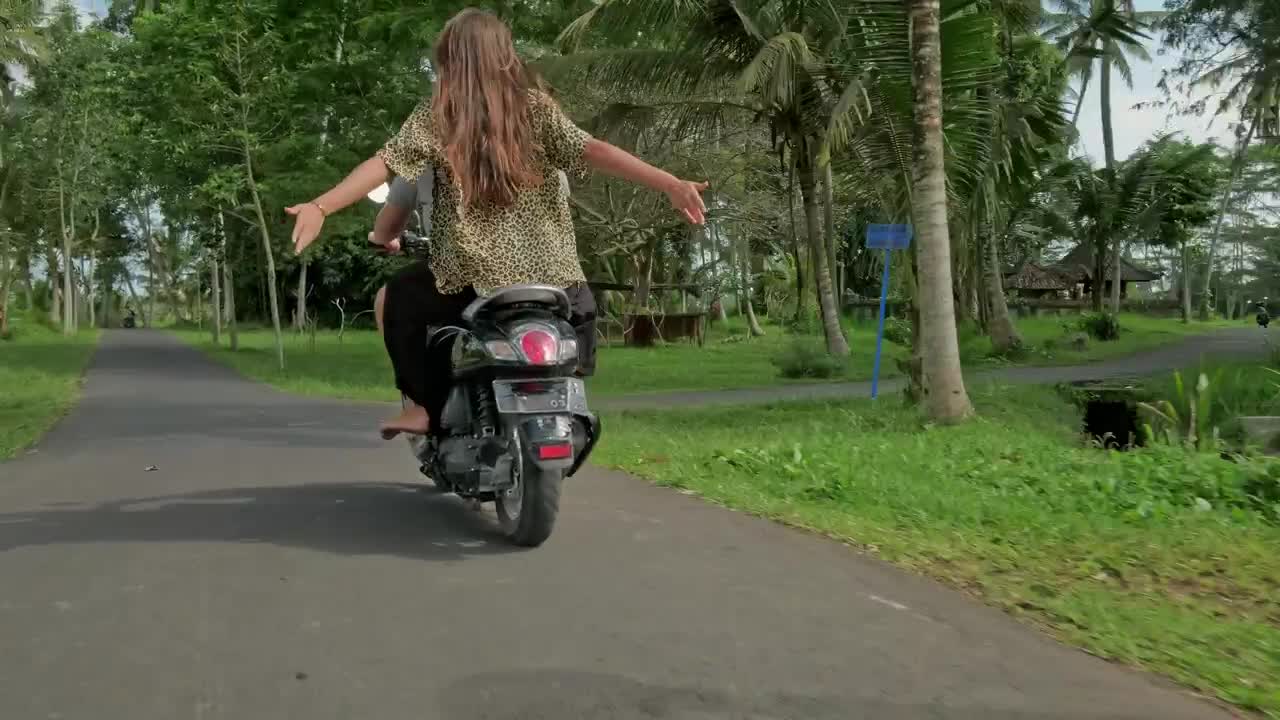 Download Stock Video Couple Enjoying A Scooter Ride On Their Vacation Live Wallpaper For PC