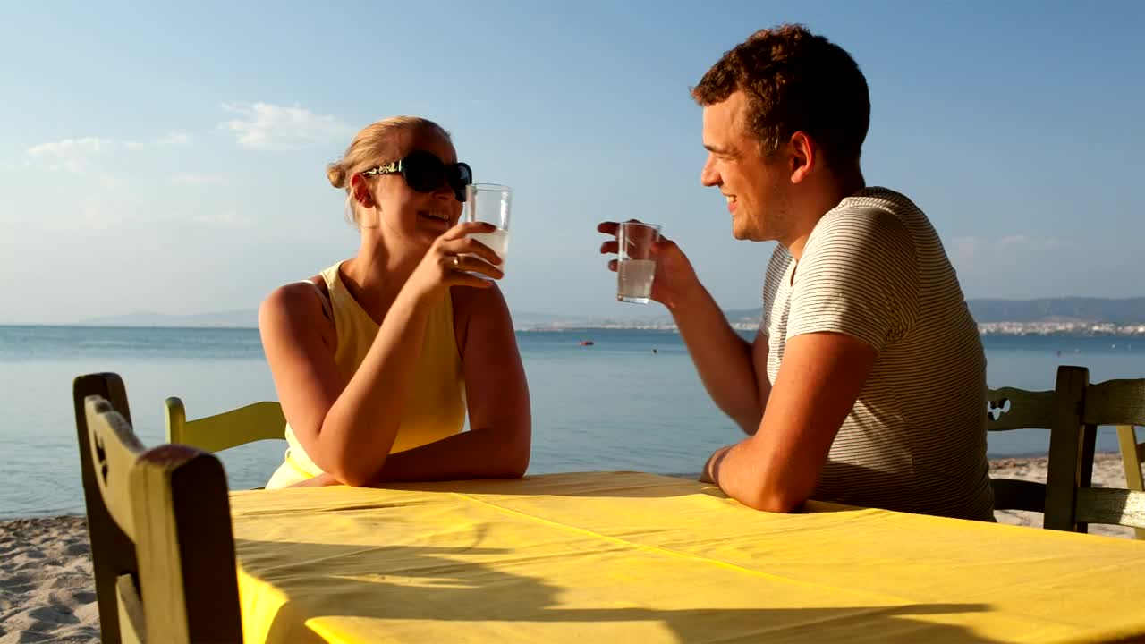 Download Stock Video Couple Enjoying A Drink At The Beach Live Wallpaper For PC