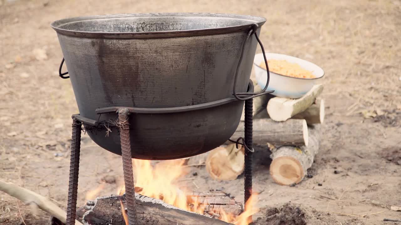 Download Stock Video Cooking Outdoors With A Cauldron In The Campfire Live Wallpaper For PC