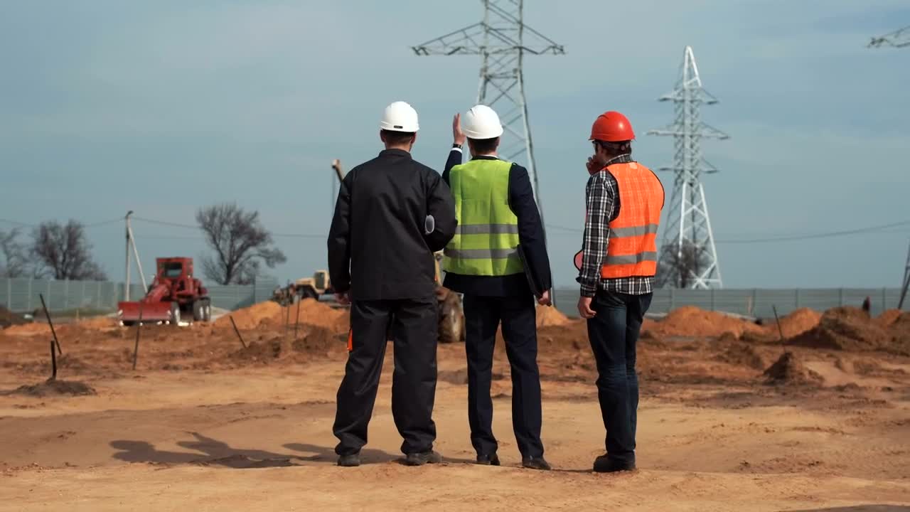 Download Stock Video Engineers Talking In Front Of The Electrical Towers Live Wallpaper For PC