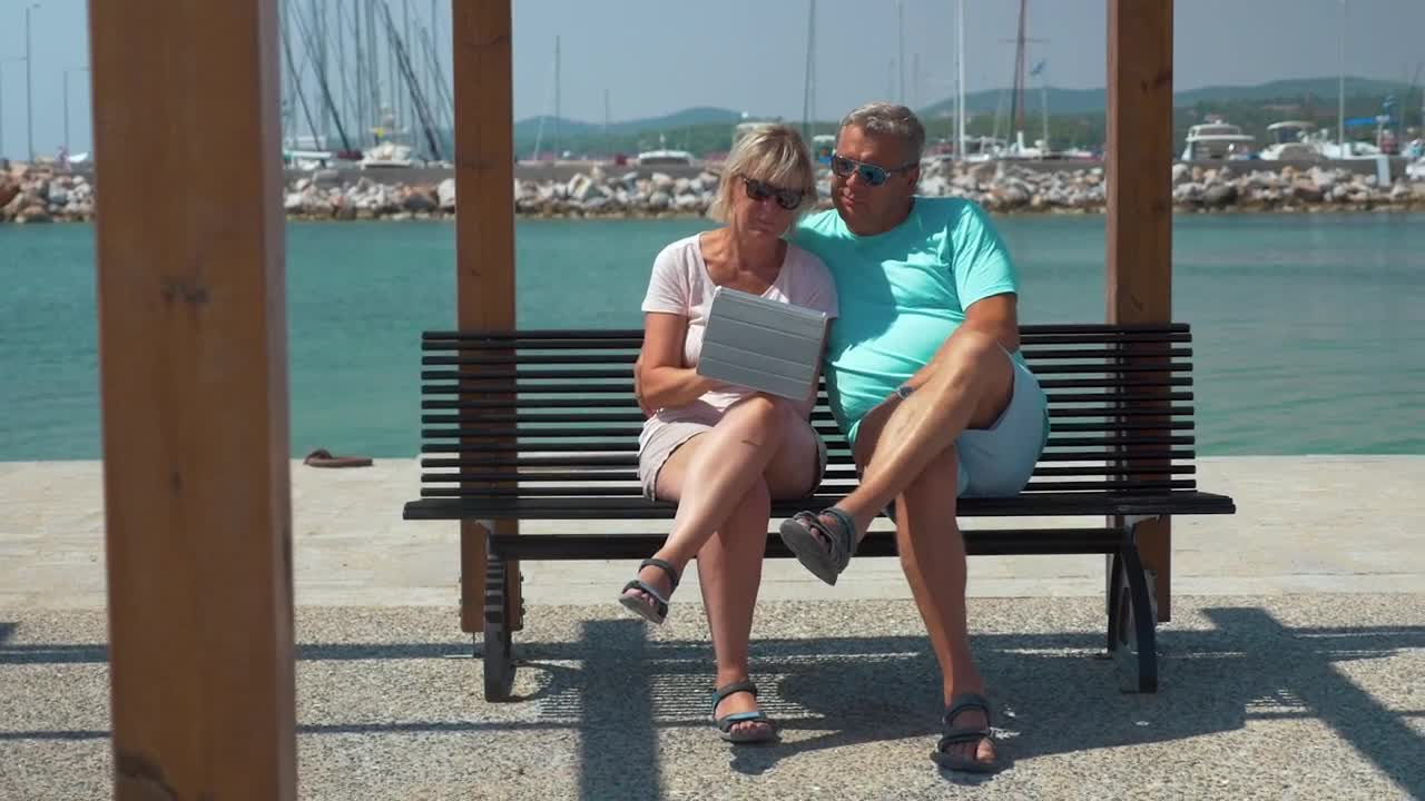 Download Stock Video Elderly Couple Using A Tablet By A Harbor Live Wallpaper For PC