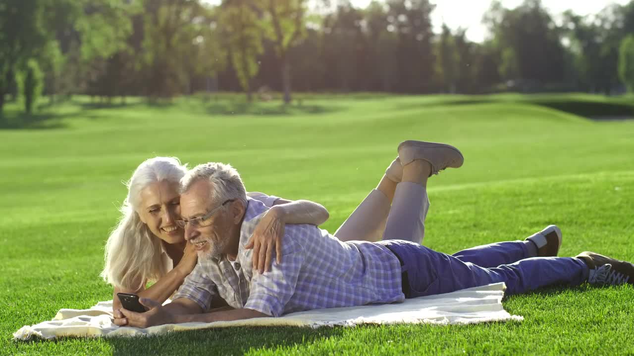 Download Stock Video Elderly Couple Using A Phone Outside Live Wallpaper For PC