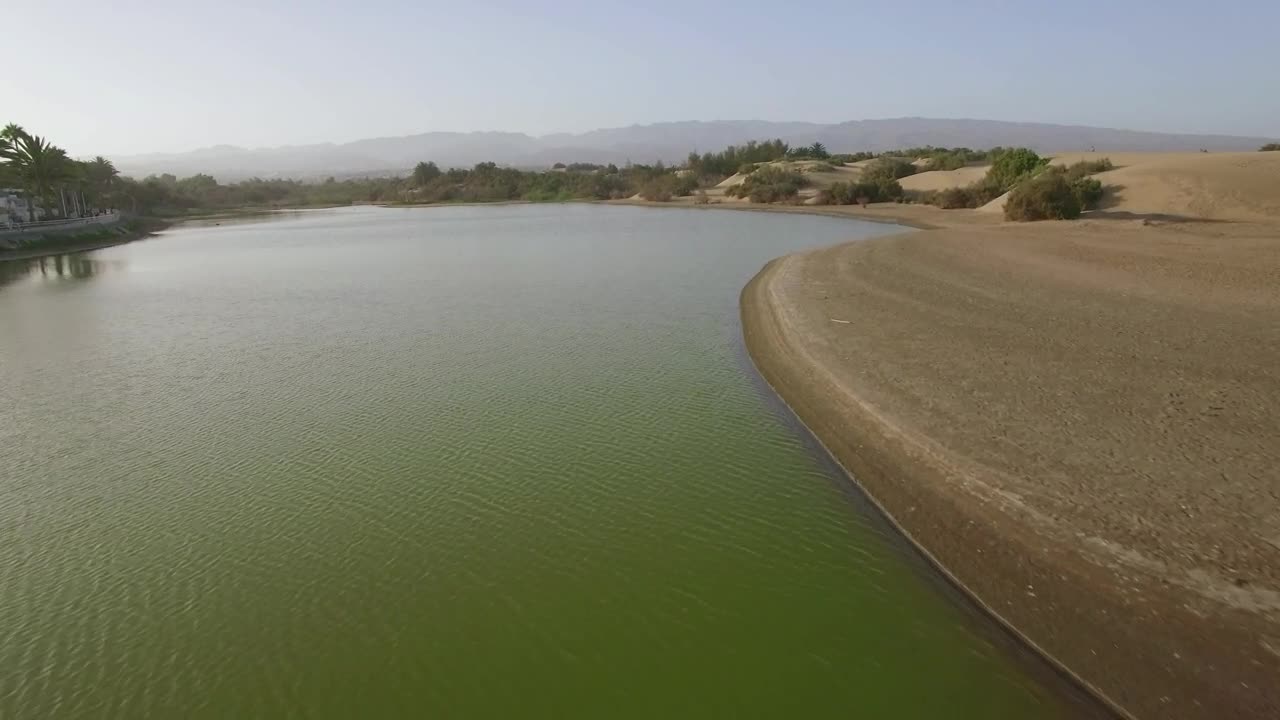 Download Stock Video Drone Heading Over A Green Lake Live Wallpaper For PC