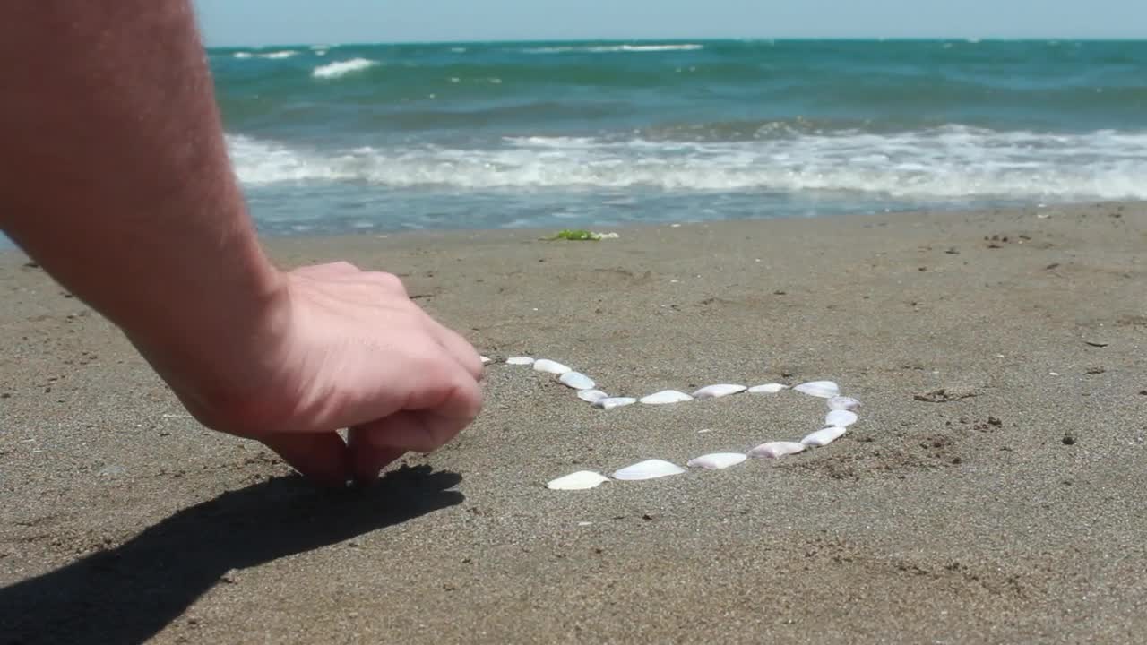 Download Stock Video Drawing A Heart On The Beach Using Oysters Live Wallpaper For PC