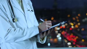 Download Stock Video Doctor Writing A Prescription With An Unfocused Street Background Live Wallpaper For PC