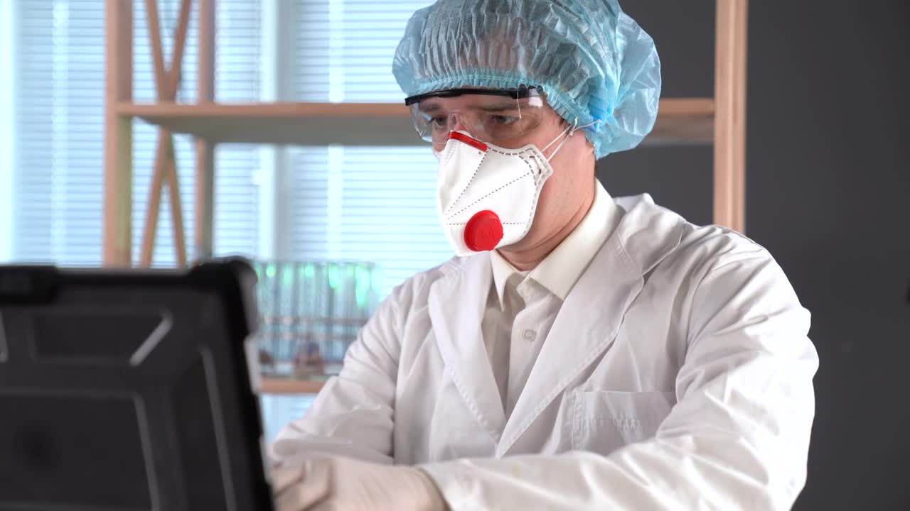 Download Stock Video Doctor Using A Facemask Typing On A Computer Live Wallpaper For PC