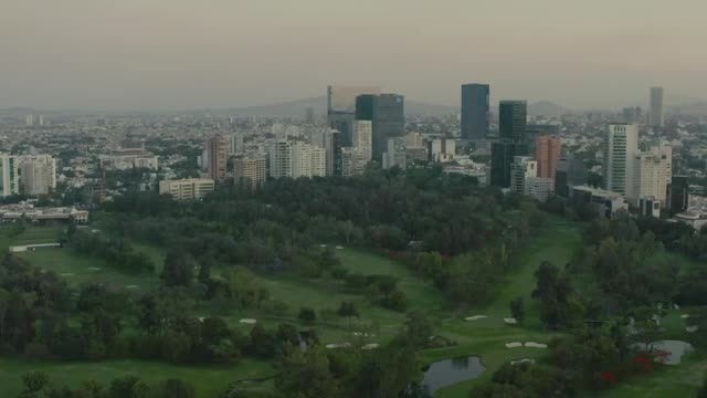 Download Stock Video Mixkit Flying Over A Large Park Surrounded By A Metropolis Smal Live Wallpaper For PC