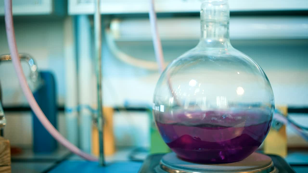 Download Stock Video Flask Of Boiling Purple Liquid In A Lab Live Wallpaper For PC