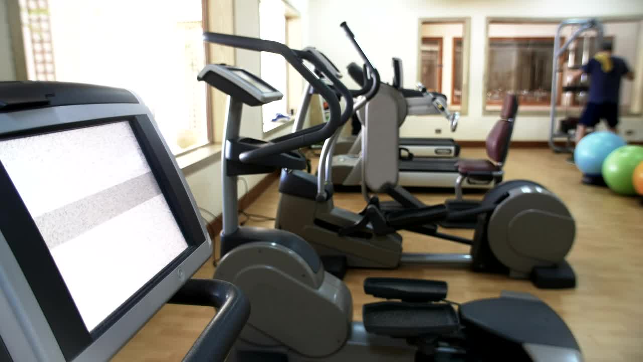 Download Stock Video Fitness Machines With A Single Man Working Out Live Wallpaper For PC