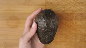 Download Stock Video Female Hands Cutting An Avocado In The Kitchen Live Wallpaper For PC