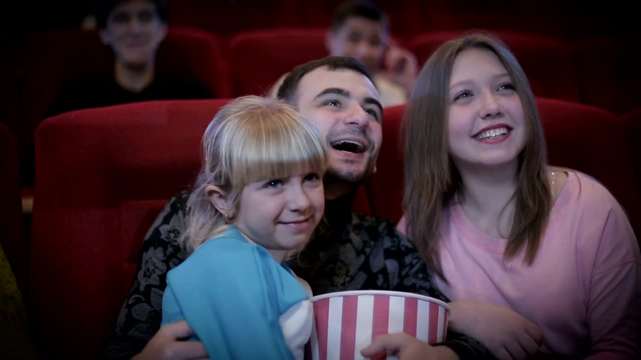 Download Stock Video Family Enjoying A Movie At The Cinema Live Wallpaper For PC