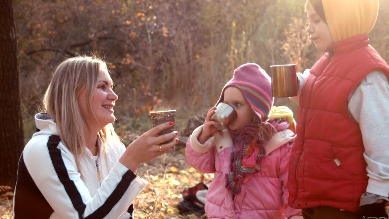 Download Stock Video Family Drinking A Hot Beverage In An Autumn Forest Live Wallpaper For PC