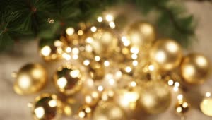 Download Stock Video Hand Holds Out Christmas Ornament With Gold Bokeh Background Live Wallpaper For PC