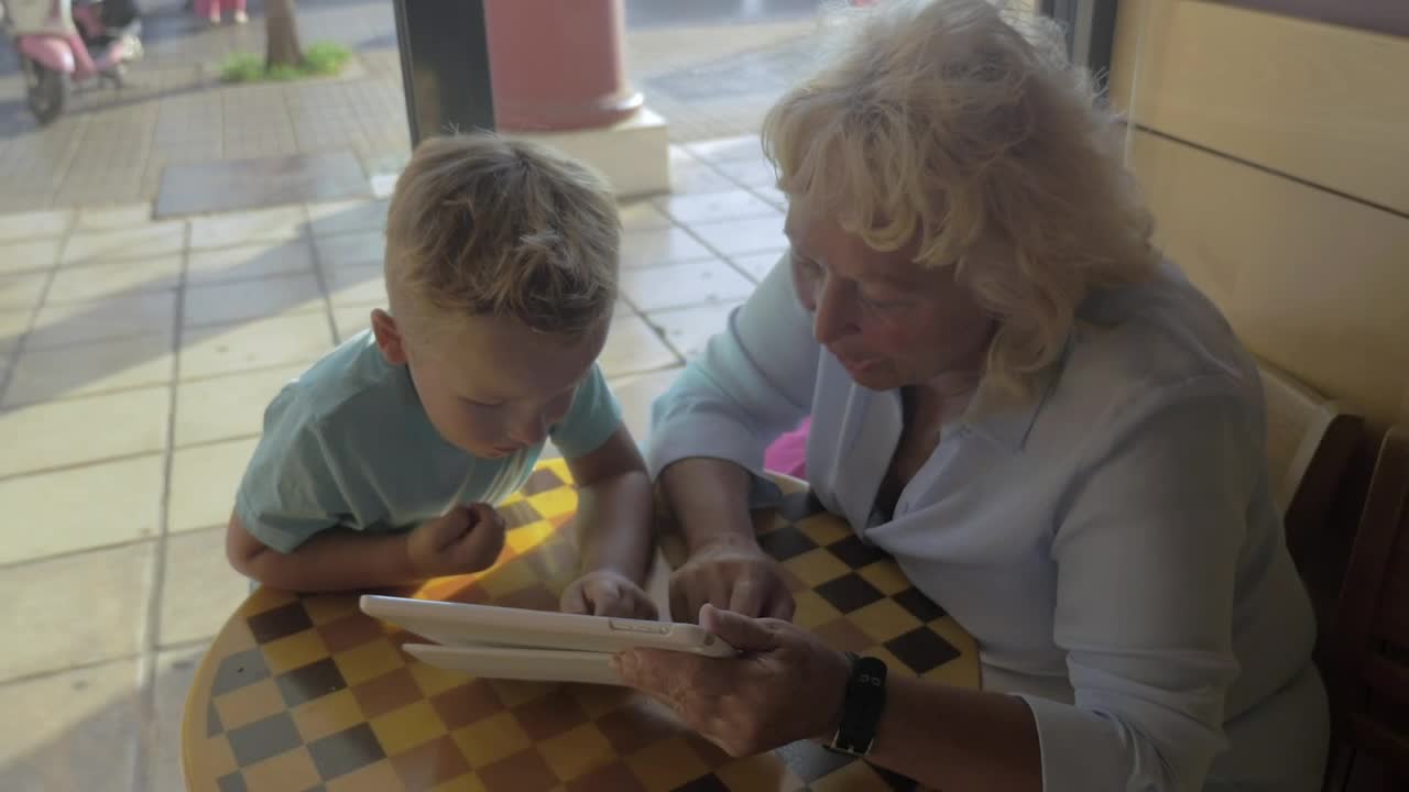 Download Stock Video Grandmother And Child Using A Tablet Live Wallpaper For PC