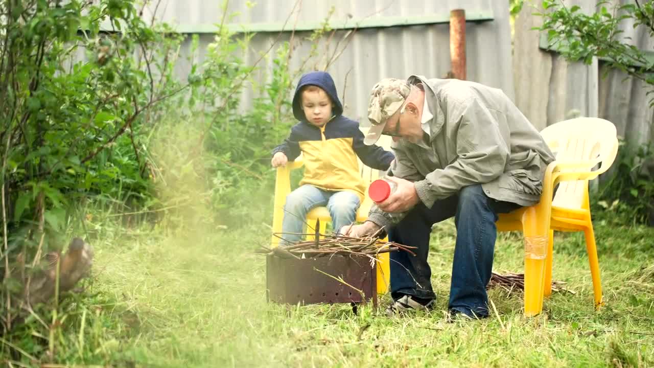 Download Stock Video Grandfather Preparing A Campfire Live Wallpaper For PC