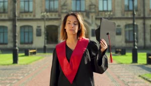 Download Stock Video Graduate Student In Gown Holding Hat Outside University Live Wallpaper For PC