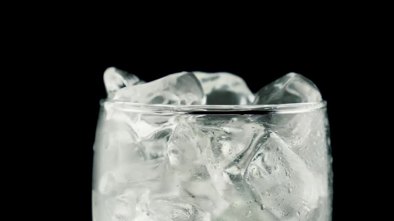 Download Stock Video Glass With Ice Filled With Soda On A Black Background Live Wallpaper For PC