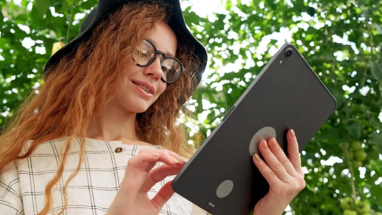 Download Stock Video Girl Using A Big Tablet In A Garden Live Wallpaper For PC